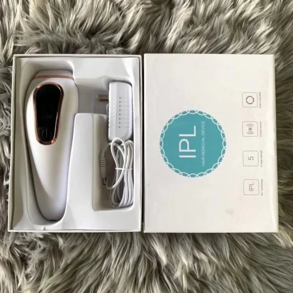 IPL hair removal device in packaging on a fluffy surface