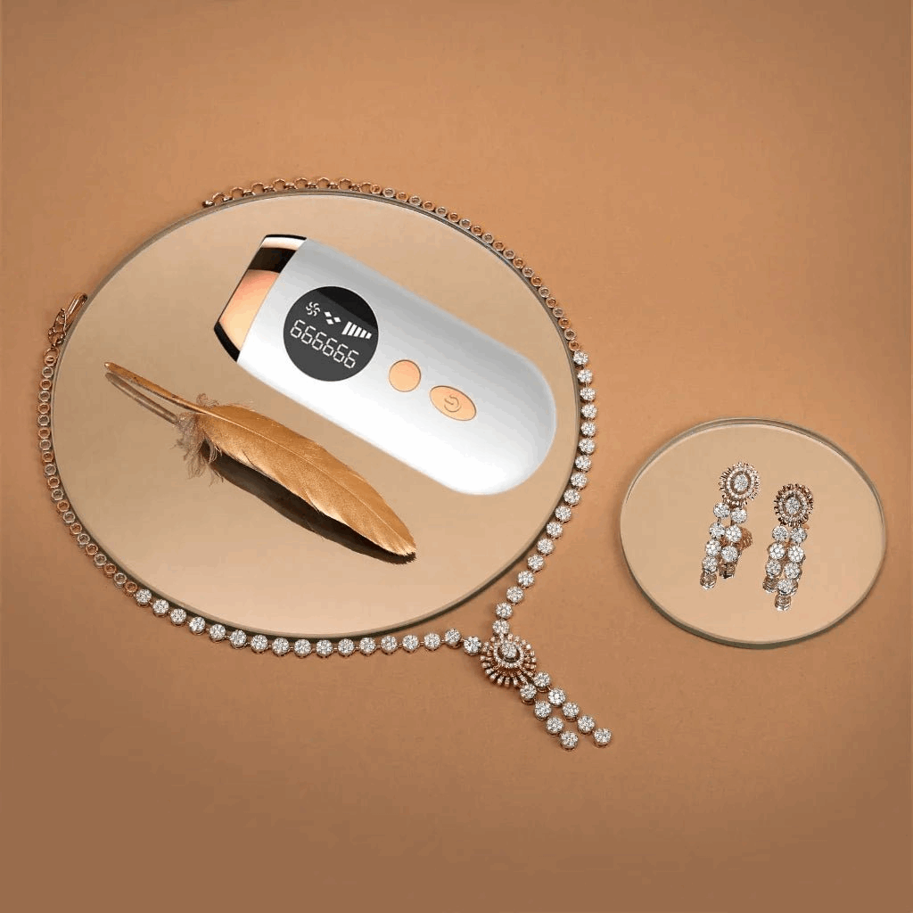 Jewelry set with a IPL hair removal device, feather, and earrings on a decorative surface.