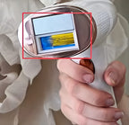 Hand holding a white IPL device with a screen displaying blue and yellow graphics.